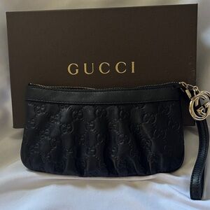 Purchased in Italy Gucci Black Embossed Leather Wristlet with Gold GG Charm